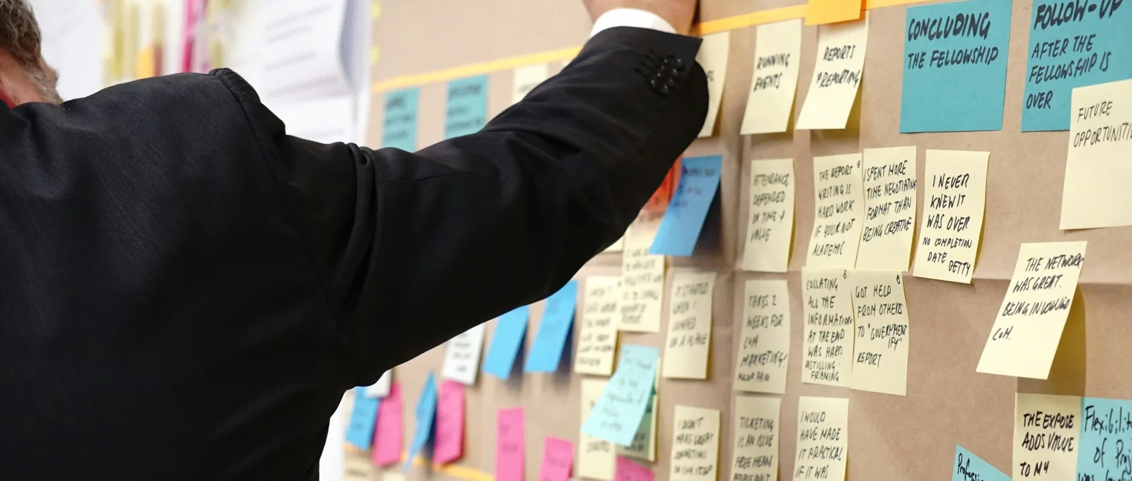 A content planning wall covered in notes: a monthly Arabic content retainer runs on a real calendar, not last-minute requests