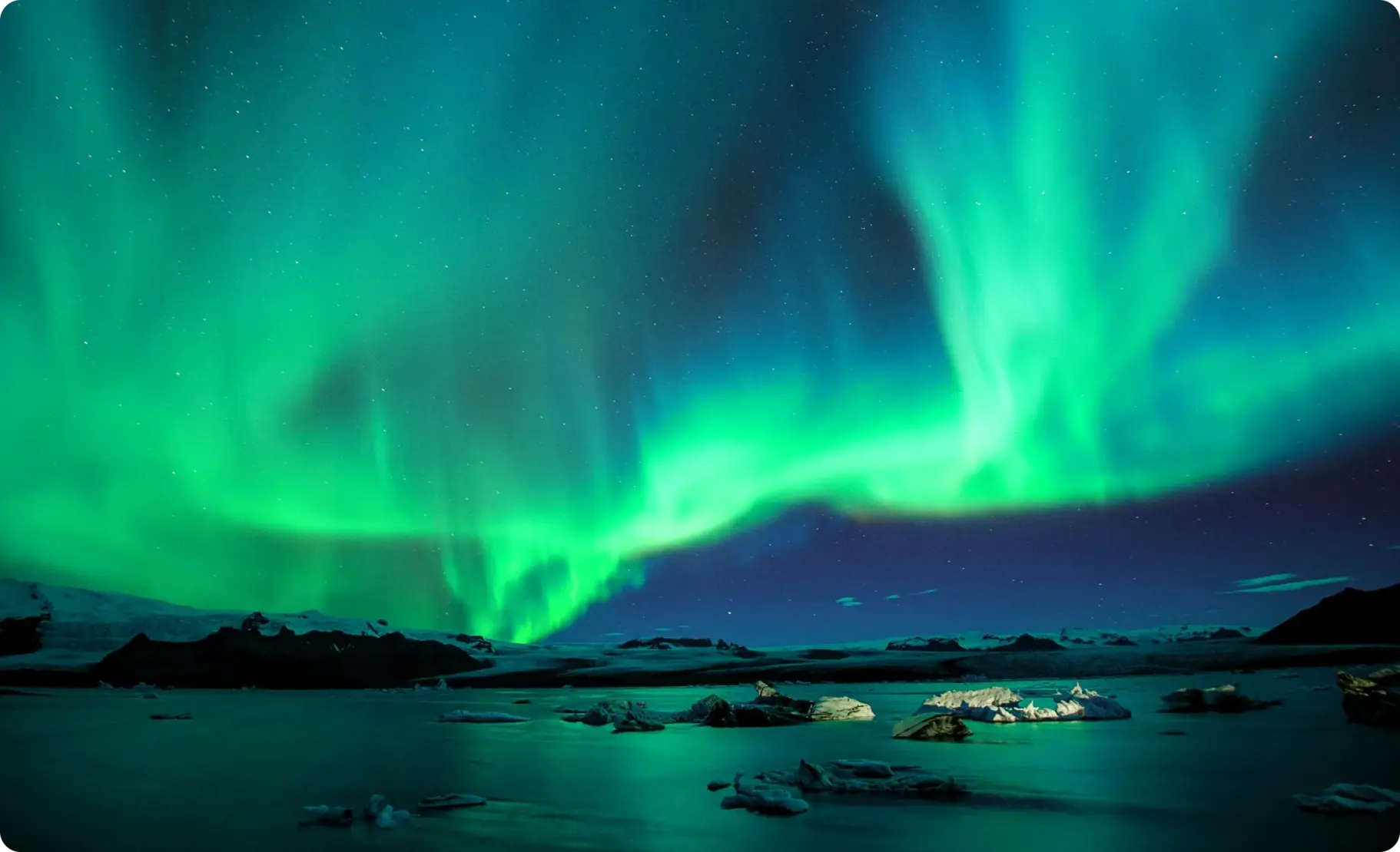 A night-time scenery featuring the Aurora Borealis also known as the northern lights, that inspired the name of the full service branding agency Aurora Hikma.