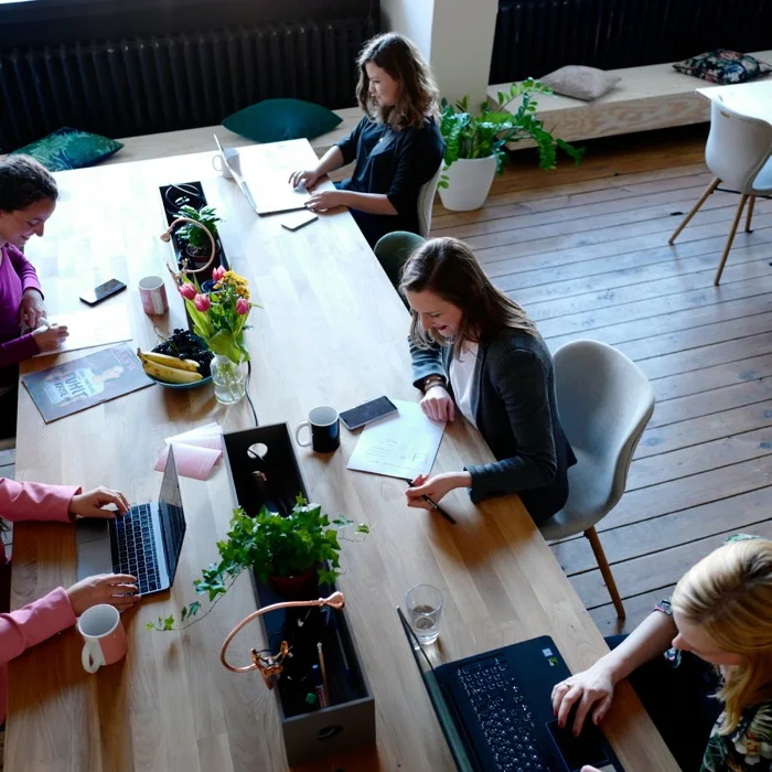 A team collaborating in a bright Dubai office, where Aurora Hikma delivers website localization for the GCC